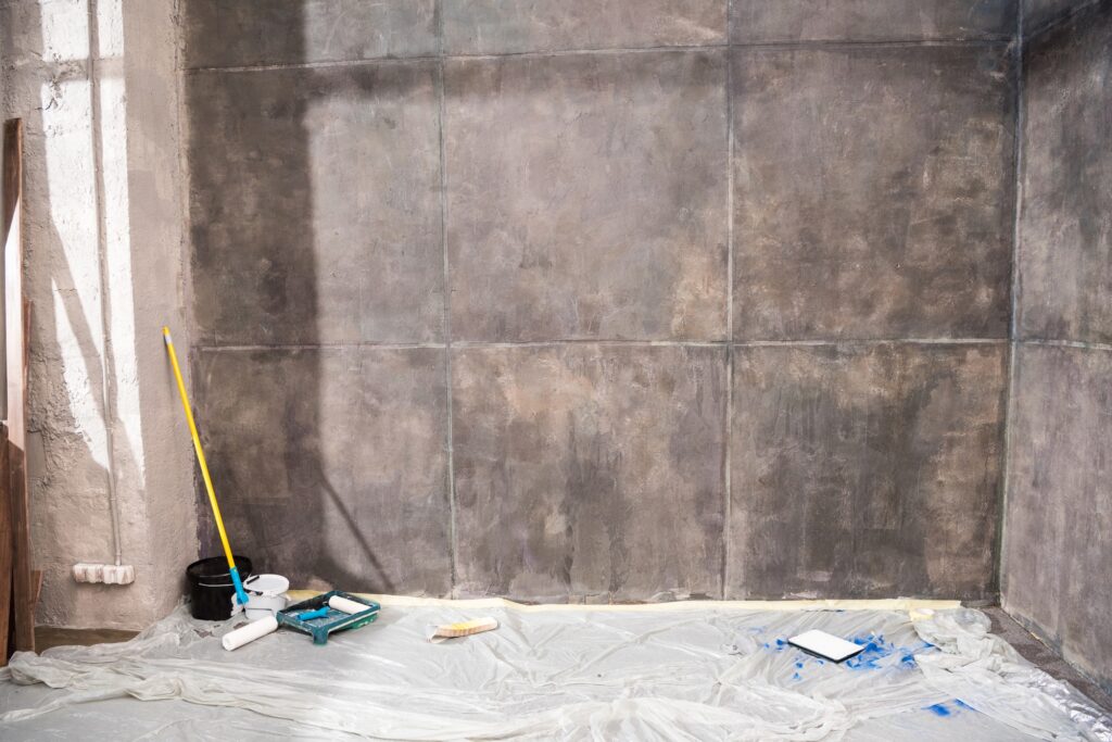 Empty room with grey walls and tools for renovation, renovation concept